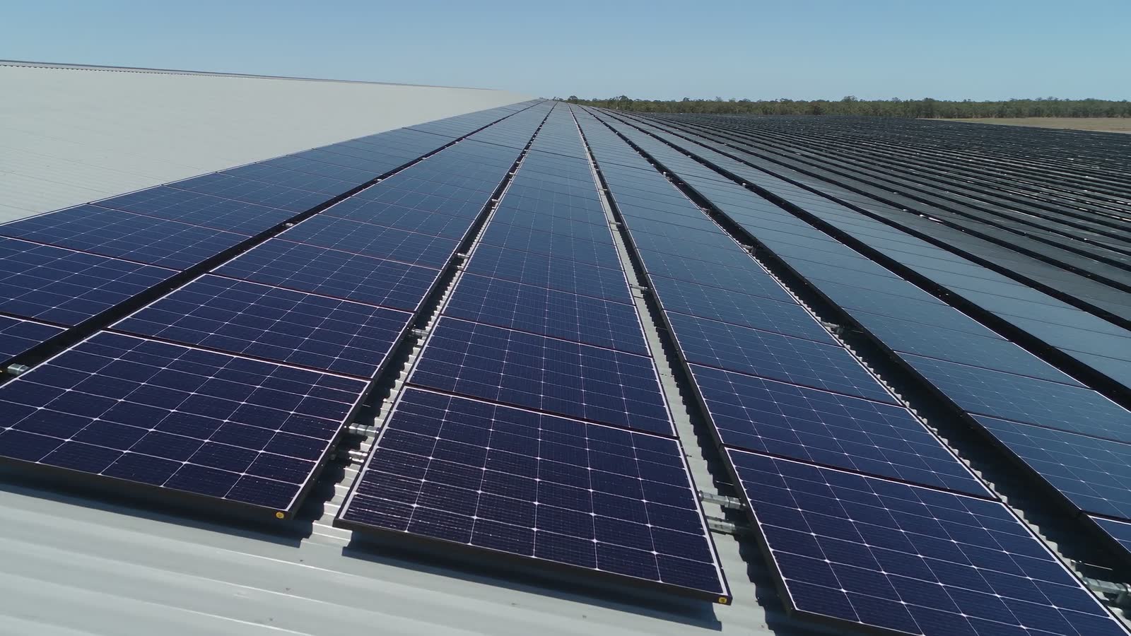 Rows of solar panels on an industrial roof