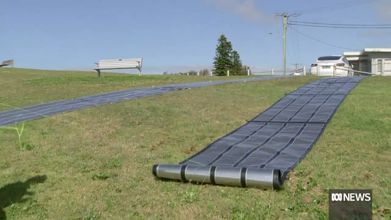 Printed Solar unrolled across a grass verge beside the road