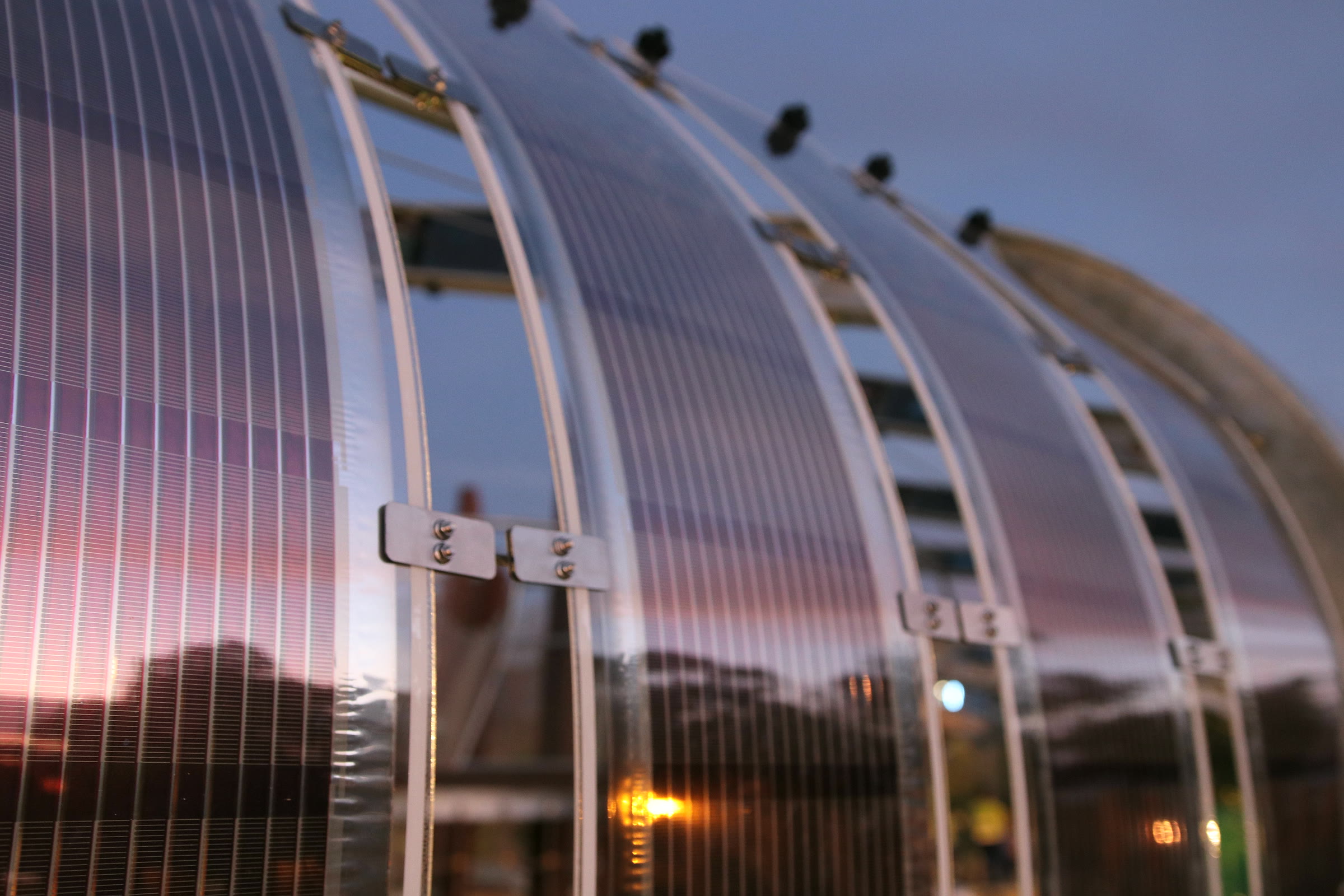 Curved Printed Solar panels on a shade structure at dusk