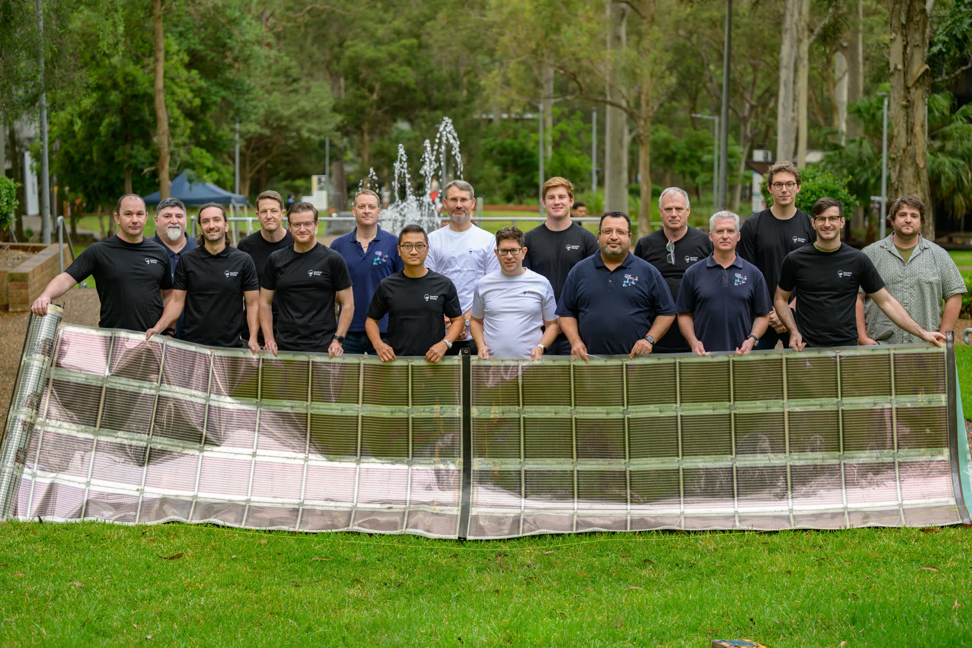 The Kardinia team standing with a sheet of Printed Solar on the lawn