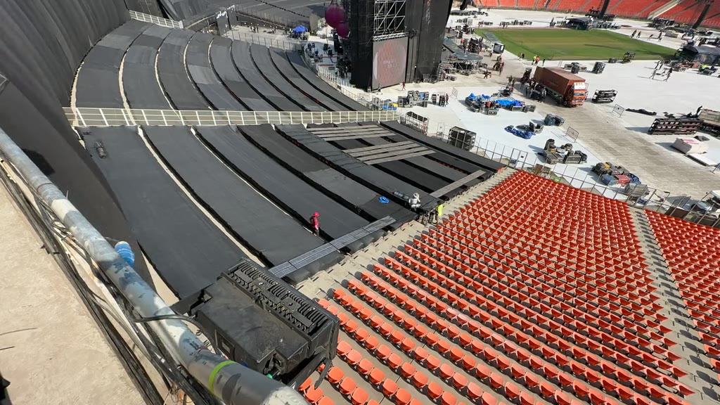 Crew rolling Printed Solar across the stands beside the stage