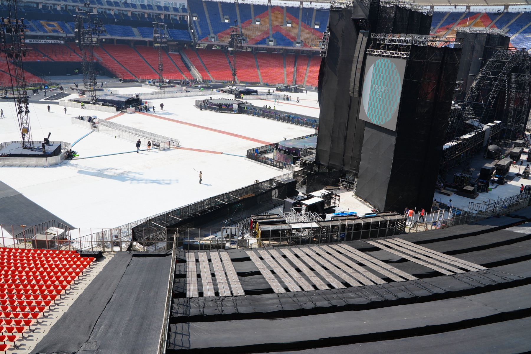 Printed Solar laid over the seating beside the stage, with the stadium field beyond